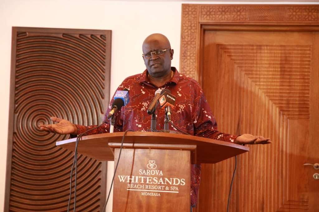 Education CS Prof George Magoha makes a presentation on the 100 percent transition policy before key Government stakeholders in Mombasa on Thursday