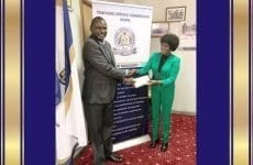 Mr. Eric Ademba, left, winner of the 2019 edition of the African Union Continental Teacher Award is congratulated by the TSC boss, Dr. Nancy Macharia. Photo/ File.