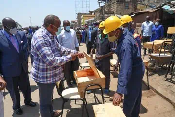 President Uhuru Kenyatta, left, launches the free school desks programme.