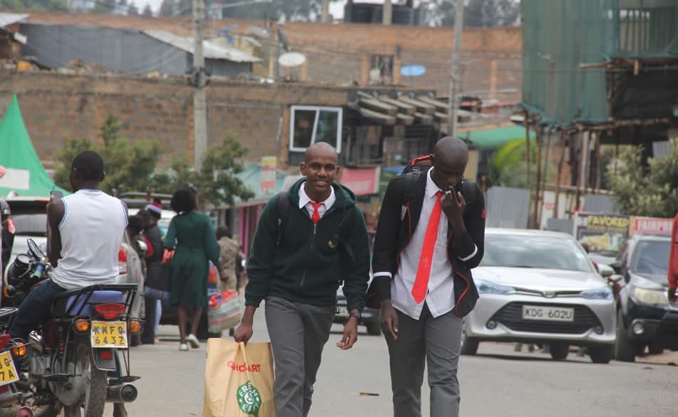 ๐๐๐ซ๐๐ง๐ญ๐ฌ ๐ฌ๐ญ๐ซ๐ฎ๐ ๐ ๐ฅ๐ ๐๐ฌ ๐๐๐ซ๐ ๐ก๐ข๐ค๐๐ฌ ๐๐ง๐ ๐ซ๐ข๐ฌ๐ข๐ง๐ ๐ฌ๐๐ก๐จ๐จ๐ฅ ๐๐จ๐ฌ๐ญ๐ฌ ๐๐ข๐ญ๐ 2 Back to school: Student are seen at public transport vehicle parking stations, waiting to be ferried back to school. There has been an outcry from parents over fare hikes.