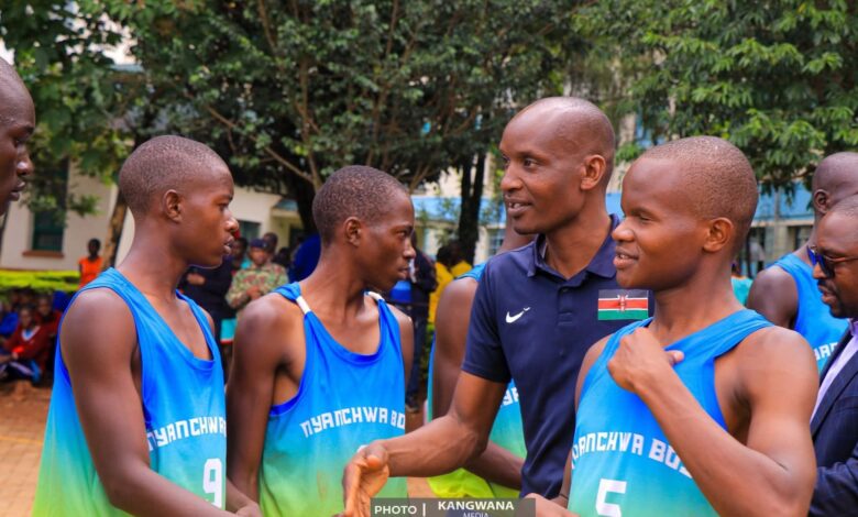 Newly elected Kenya Union of Post Primary Education Teachers, Kuppet, Kisii Branch Simeon Ongaga (centre) greets Nyanchwa Boys' Basketball Players at this year's Kisii County Finals. Kisii school emerged winners. Photo Courtesy of Kangwana Media.